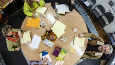 Full cast around the writer's table