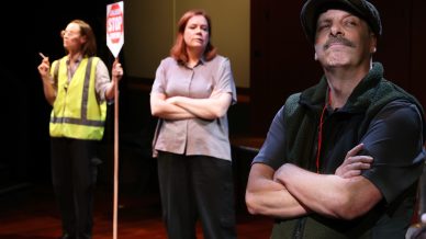 Three adults stand indoors; a man in front wears a cap and crosses his arms, looking confident. Behind him, a woman stands with arms crossed, and another woman in a safety vest holds a Stop sign and a cigarette.
